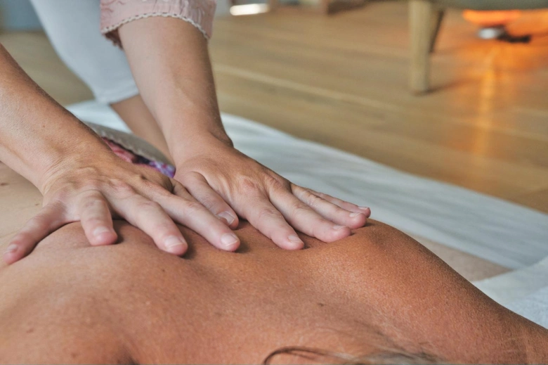 How can a massager replace expensive sessions with a chiropractor?